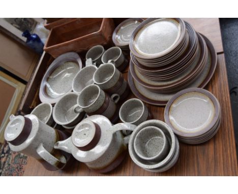 A grey dappled stoneware part dinner service including tea and coffe pots, mugs, plates of various sizes, and bowls