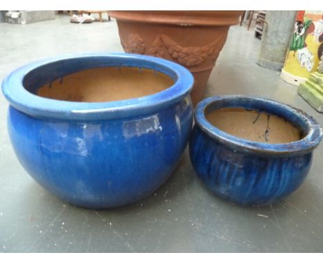 A blue glazed stoneware planter and another smaller of a similar design (2)