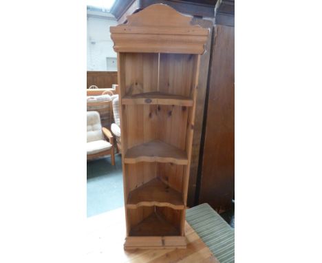 A pine corner shelf unit with three carved shelves 