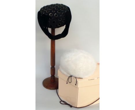 A soft white faux fur hat labelled 'Marzi' and a further Mitzi Lorenz black cocktail hat in a pillbox style and with black ve