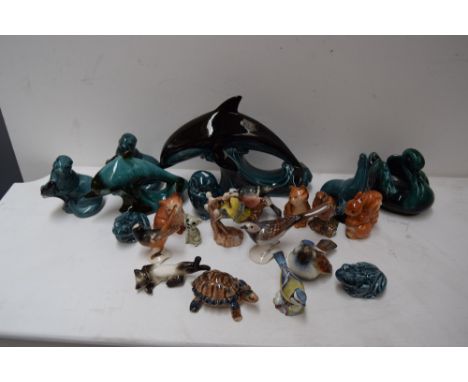 A collection of figurines including Poole pottery, Beswick, Wade and Goebel