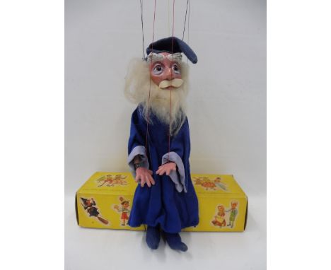 A boxed Pelham Puppet - Walt Disney character Merlin from Sword in The Stone, 1960s, age related marks to cuff, felt hat slig