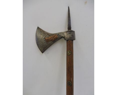 Possibly an Indian war axe, having copper figures overlaid on the steel head and mounted on a wooden shaft with brass decorat