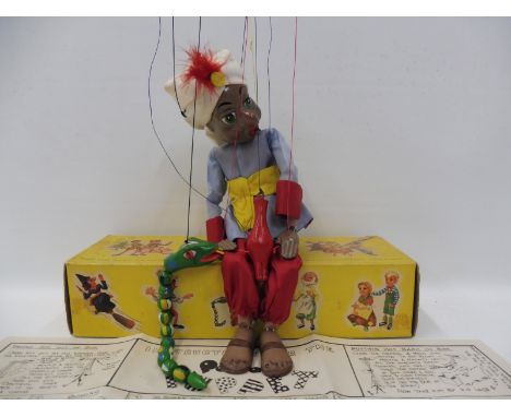 A boxed Pelham Puppet - Snake Charmer, early 1960s with original strings, instructions and controller.