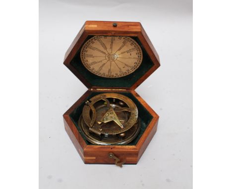 Gilbert and Son, London, compass and sundial , bronze in hexagonal wooden box. 12x12cm  