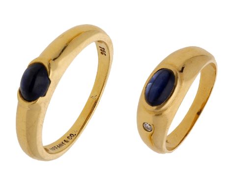 A sapphire ring by Tiffany & Co. and another sapphire ring, the first set with an oval sapphire cabochon to a tapering bombé 