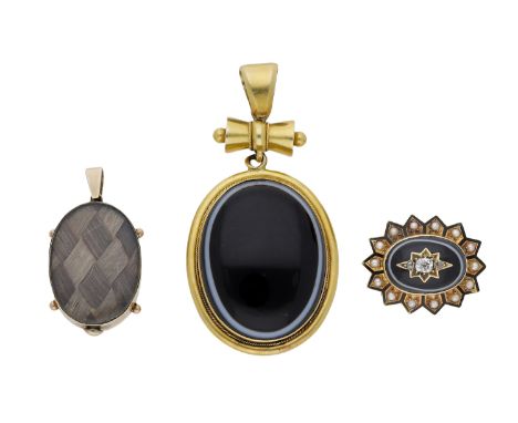 Two mid/late 19th century mourning lockets and a brooch, the first set with a banded onyx cabochon within a ropetwist border 