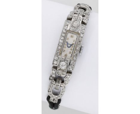 Swiss. A lady’s platinum and diamond-set rectangular Art Deco cocktail watch, circa 1930. Movement: manual winding. Dial: sil