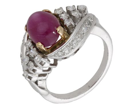 A ruby and diamond dress ring, of stylised crossover design, the ruby cabochon with a cluster of single-cut diamonds to eithe