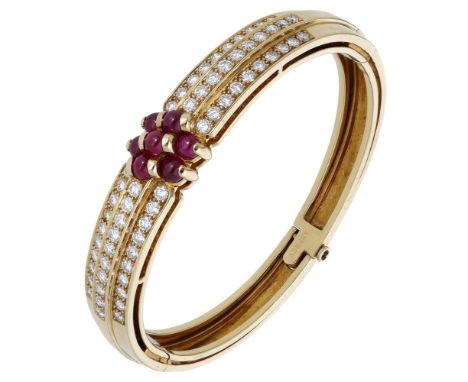 A French ruby and diamond bangle by Serge Bouder for Asprey & Co., the hinged cuff with three stepped rows of brilliant-cut d