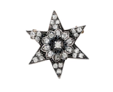 A late 19th century diamond star brooch, with a flowerhead cluster to the centre and set throughout with cushion-shaped and o