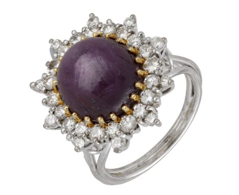 A star ruby and diamond cluster ring, the circular star ruby cabochon within a surround of brilliant-cut diamonds, total diam