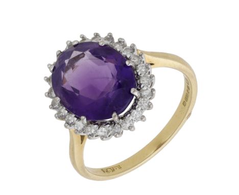 An 18ct gold amethyst and diamond cluster ring, 1986, the oval-cut amethyst within a surround of brilliant-cut diamonds, tota