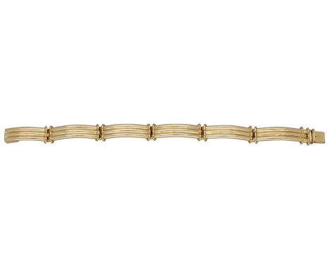 A fancy-link bracelet, designed as a series of curved and reeded panels, stamped ‘750’, length 18.5cm. £1,500-£2,000  ---  Co