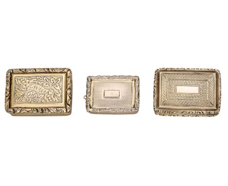 Three 19th century silver gilt vinaigrettes, of rectangular form, the first with scrolling foliate engraved decoration, withi