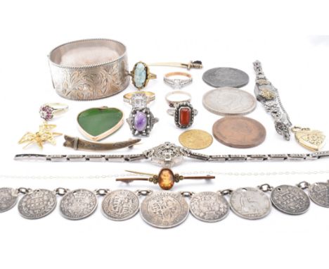 A selection of jewellery dating from the Edwardian era onwards to include a silver hallmarked bangle bracelet, a silver sword