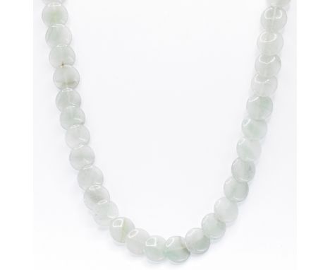 A jade beaded necklace having strung round flat beads beads on a gold pierced navette shaped clasp. Clasp unmarked but tests 