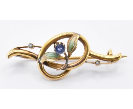 A 19th Century Victorian 9ct gold, sapphire, enamel and seed pearl flower brooch. The brooch of knot design with an enamelled