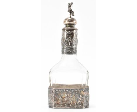 A 1920's German continental silver decanter bottle having repousse decorated silver collars to the base and neck decorated wi