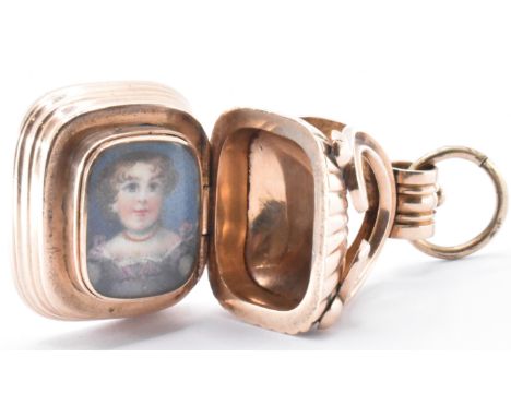 A 19th Century William IV Regency seal fob locket. The fob being set with a carnelian intaglio to the base engraved with a co