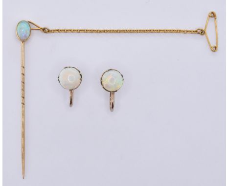 A early 20th Century gold stick pin bezel set with an oval opal cabochon to the head together with a pair of opal screw back 