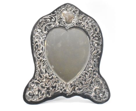 An early 20th Century Edwardian silver fronted photo frame having a bevelled glass heart shaped mirror to the centre. The fra