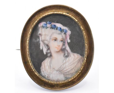 A 19th Century Victorian portrait miniature brooch having a mother of pearl panel to the centre depicting an 18th Century Geo