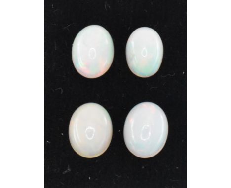 Four oval opal cabochon stones. Stones giving a full spectrum of colour. Measures; 8.8 x 6.9 x 4.3mm, 9 x 7 x 3.9mm, 9 x 7 x 