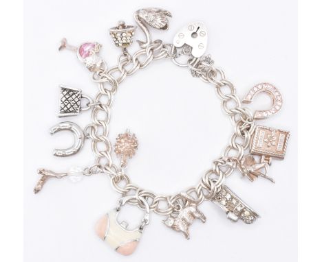 A vintage silver charm bracelet having a double curb link bracelet and heart lock clasp. The bracelet having thirteen charms 