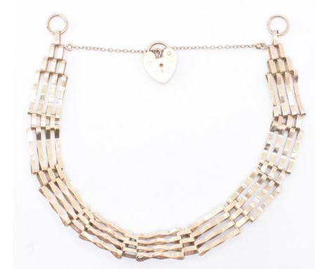 A hallmarked 9ct gold gate link bracelet. The bracelet formed of a four bar gate link chain united by heart lock clasp having