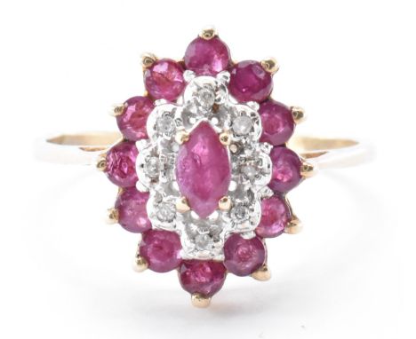 A hallmarked 9ct gold diamond and ruby cluster ring. The ring having a navette shaped head set with a central marquise cut ru