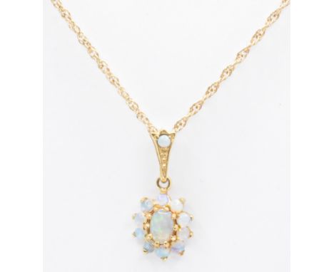 A hallmarked 9ct gold and opal pendant necklace. The necklace strung with a hallmarked opal cluster pendant set with 11 opal 