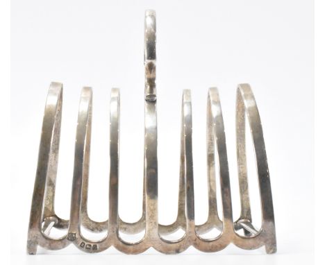 A 1930's Art Deco era Barker Brothers silver hallmarked toast rack of arched form having a finial handle to the top. Hallmark