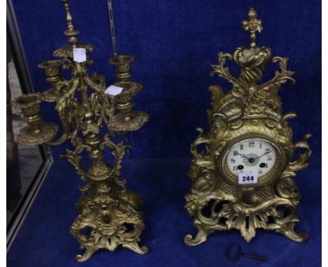 A late 19th/early 20th Century French gilt metal mantel clock with an enamel dial and scrolling foliage decoration 43cm high 