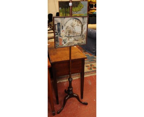 A George III style mahogany pole screen with needlework panel