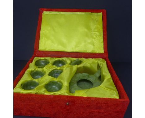 A boxed Chinese jade tea set, to include teapot, six cups and a tray, H.7 W.12 D.17cm (teapot), W.22 D.15cm (tray), H.2cm Dia