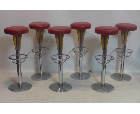 A set of six vintage heavy chrome bar stools with red leather seats 