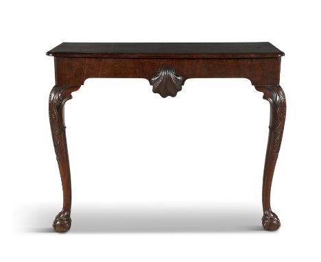 AN IRISH MAHOGANY CONSOLE TABLE, 19TH CENTURY   of rectangular form, with moulded rim above plain frieze with central carved 