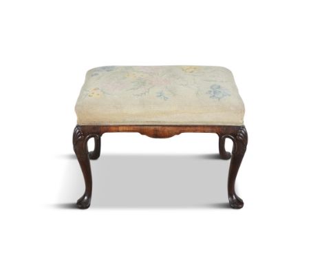 A CARVED WALNUT UPHOLSTERED STOOL, 19TH CENTURY    of oblong shape, with needlework tapestry seat, on shell capped cabriole l