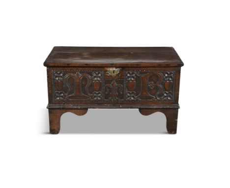 A SMALL 17TH CENTURY CARVED OAK COFFER,  the two plank hinged above a carved front with initials 'M R' centred with carved fl