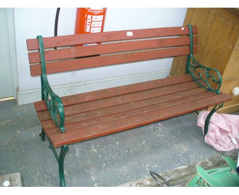 A Painted iron and slatted hardwood garden bench.