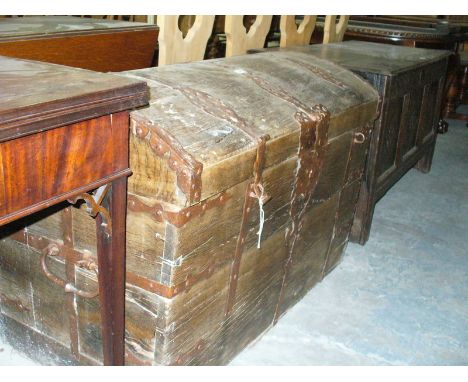 A 17th Century iron bound oak domed trunk
Flanked by twin carrying handles, some restoration and further damage throughout, w
