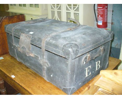 A Vintage travel trunk with leather straps.
