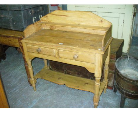 A Victorian pine washstand , the raised back with a single shelf above a rectangular top two frieze drawers and an undershelf