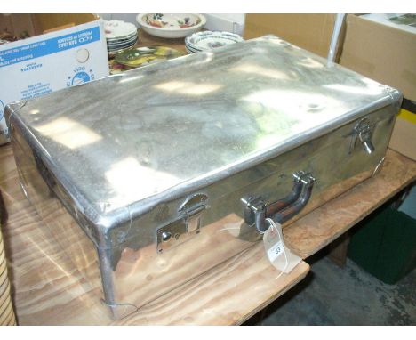 A Vintage chromed trunk with a leather handle.