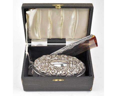 A cased hallmarked silver mounted brush and comb set. The lot to inlcude a hallmarked silver mounted brush, filled. Hallmarke
