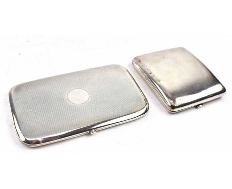 Two George V hallmarked silver cigarette cases. The lot to include a George V hallmarked silver cigarette case. Hallmarked ye