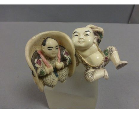 Two Netsuke including boy lying down and man in seat with face to back