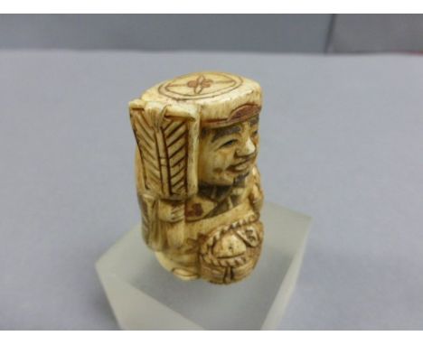 Signed Oxbone Netsuke of a man with basket and fan
