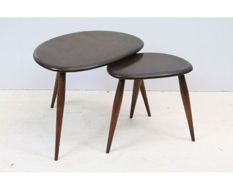 Ercol nest of two dark oak pebble tables, the largest, 36cm high x 49.5cm wide (top) x 34cm deep (top) 